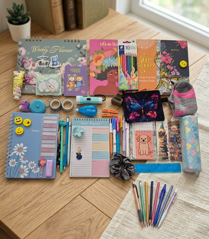 Contents of a stationery surprise box including notebooks charms and planners